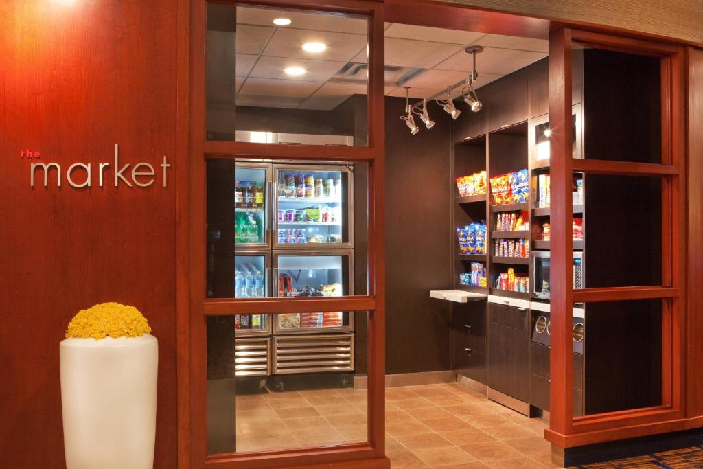 The lobby market, with glass-fronted drinks coolers, shelves of snacks, a microwave and a self-checkout counter