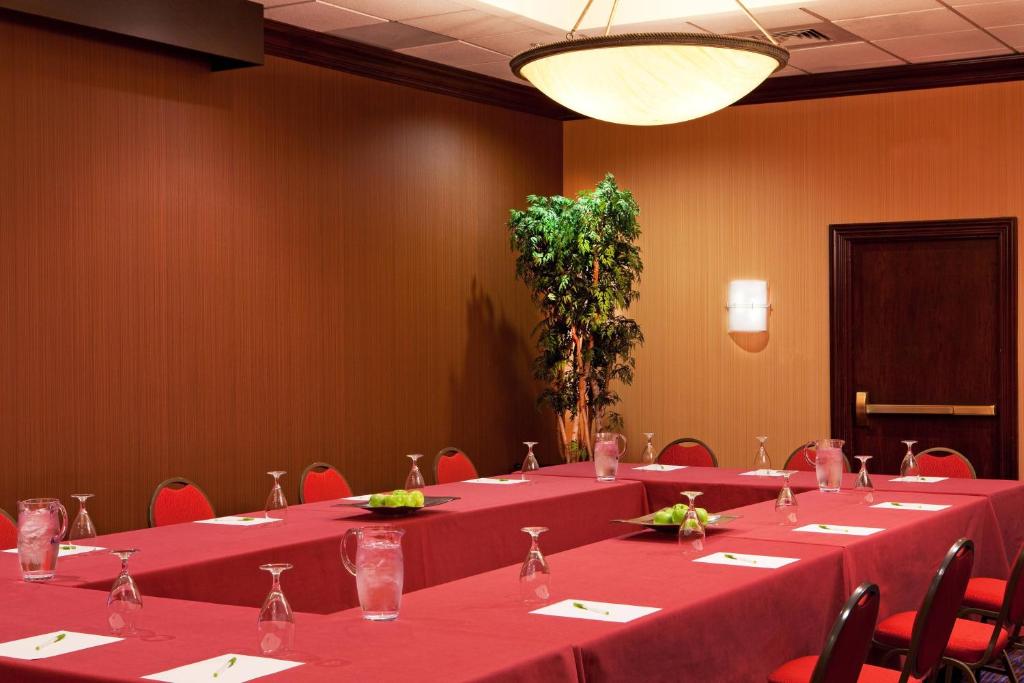 The room set in a U-shape, with places laid along the tables and a screen at the open end