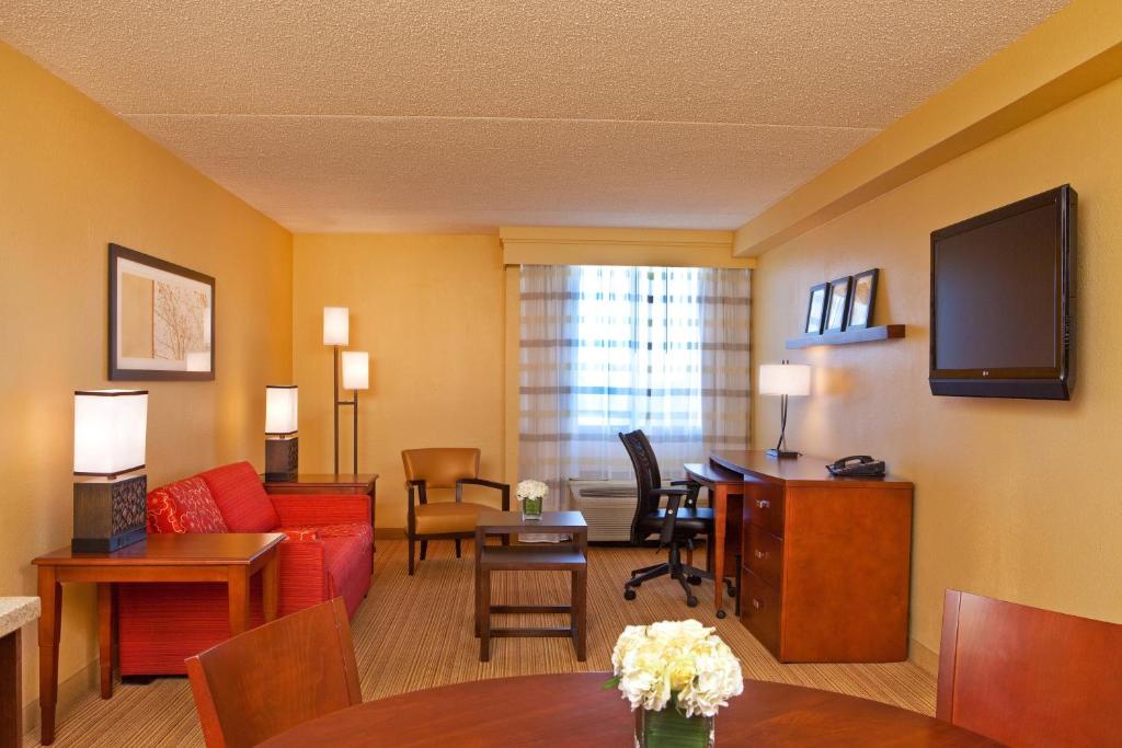 Suite living area with sofa, dining table and work desk